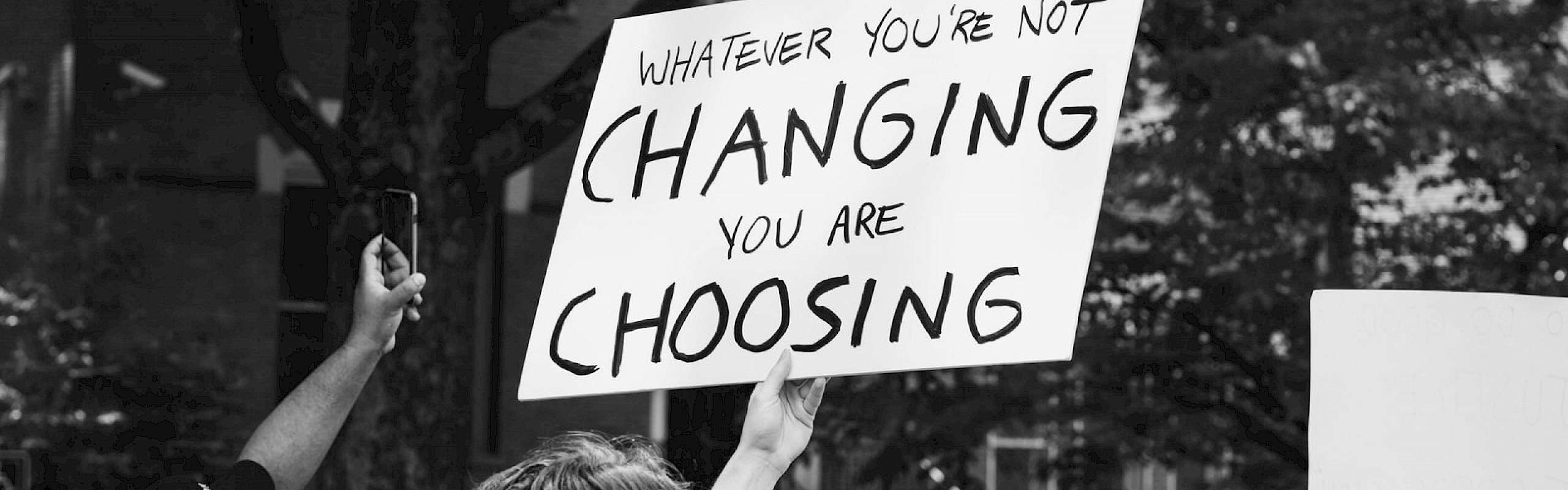 Man holding a sign up in protest